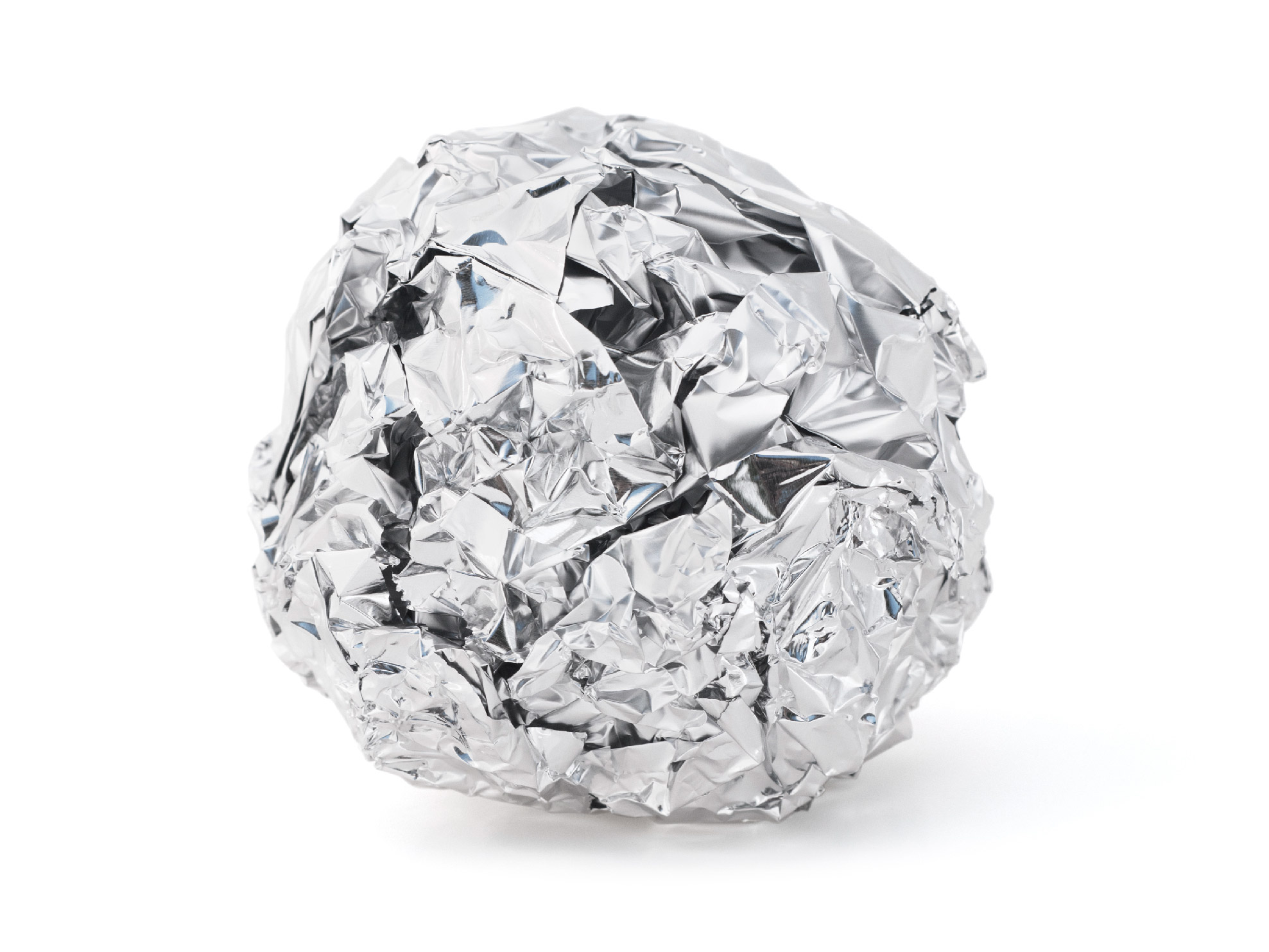 A crumpled ball of foil in front of a white background