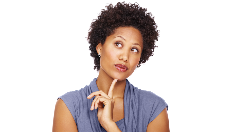 Black woman with a beautiful curly afro holds her left index finger to her chin, contemplating 