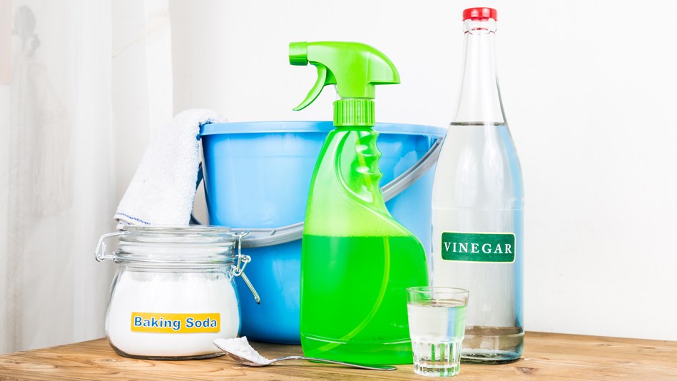 A group of cleaning items including vinegar and baking soda